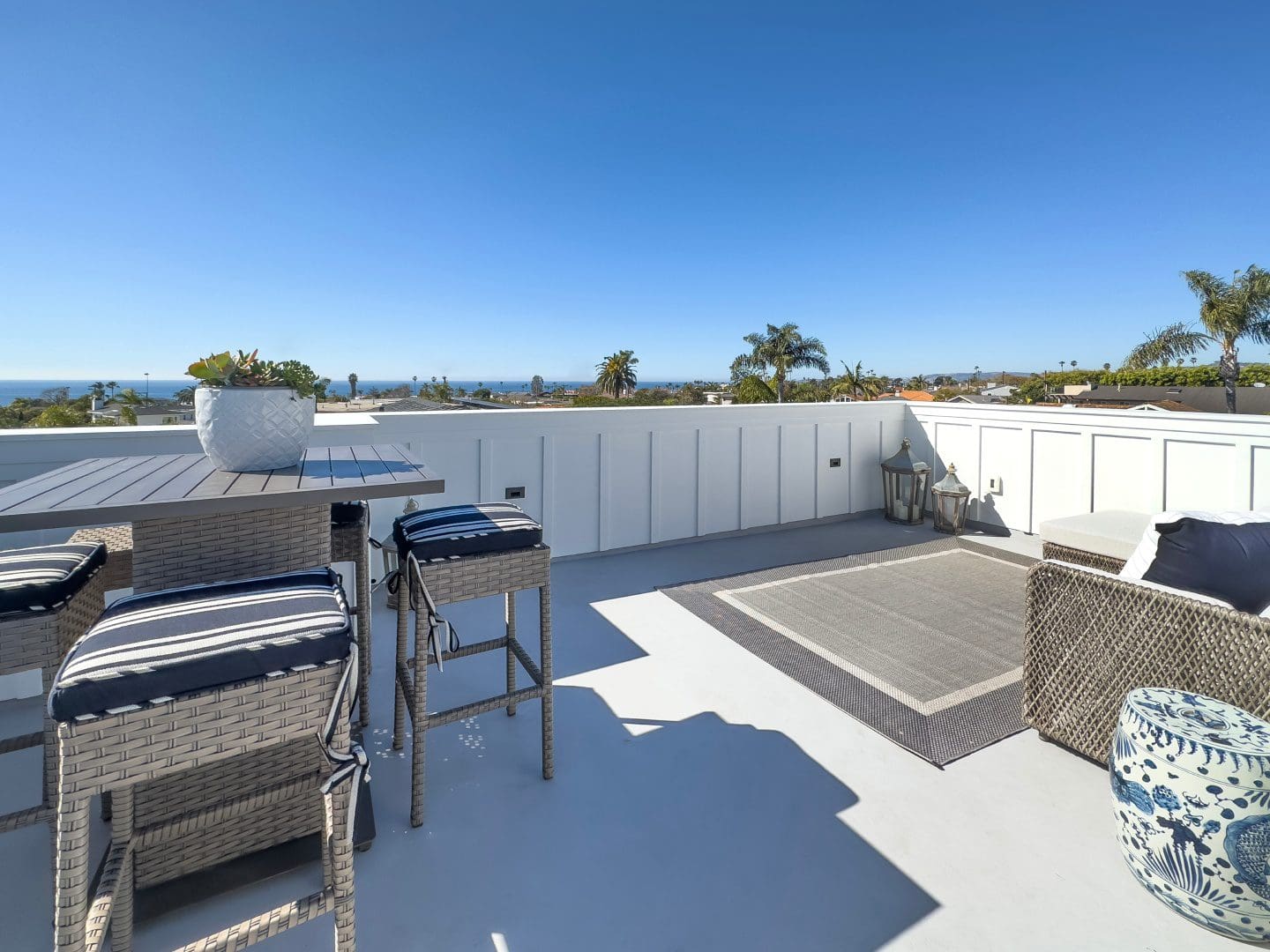 Table and chairs on terrace with sky view