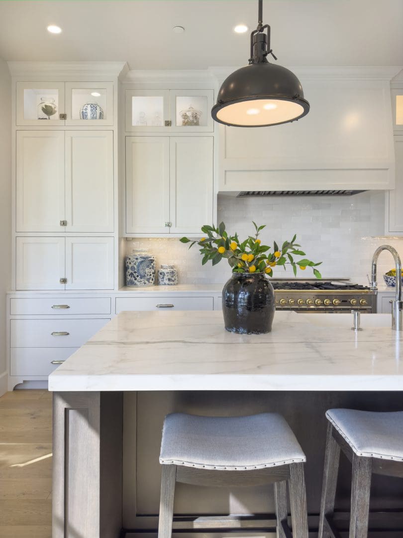 View of the flower vase on countertop and a hanging light