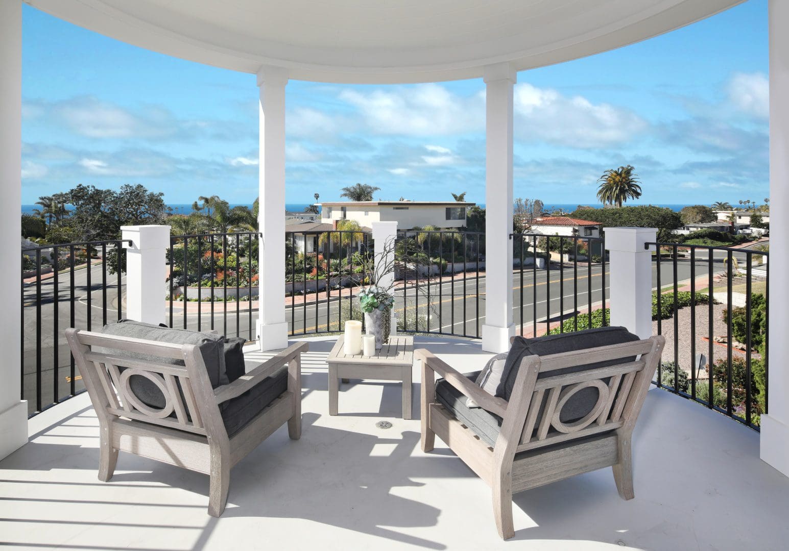 View of the city from the balcony with two chairs