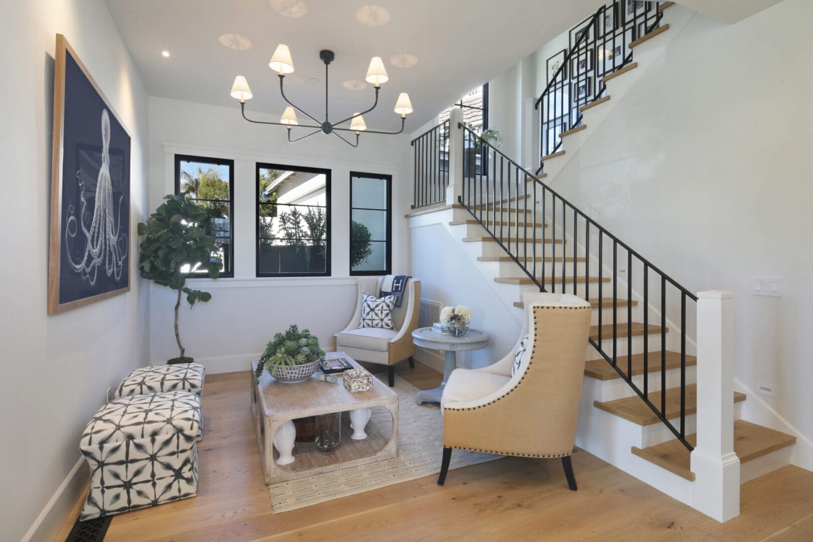 View of staircase inside the house with sofas and table