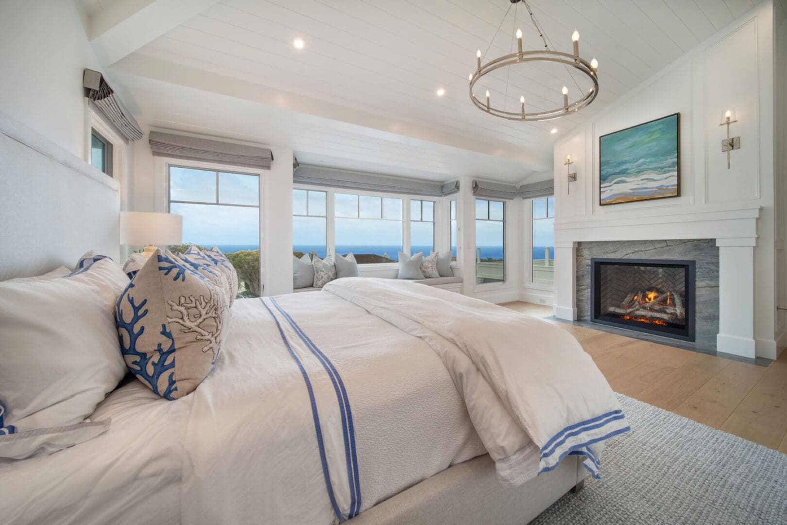 A bedroom with a fireplace and a large bed.