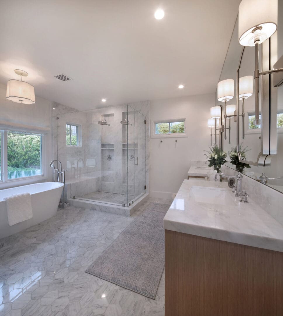 A white bathroom with a large tub and sink.